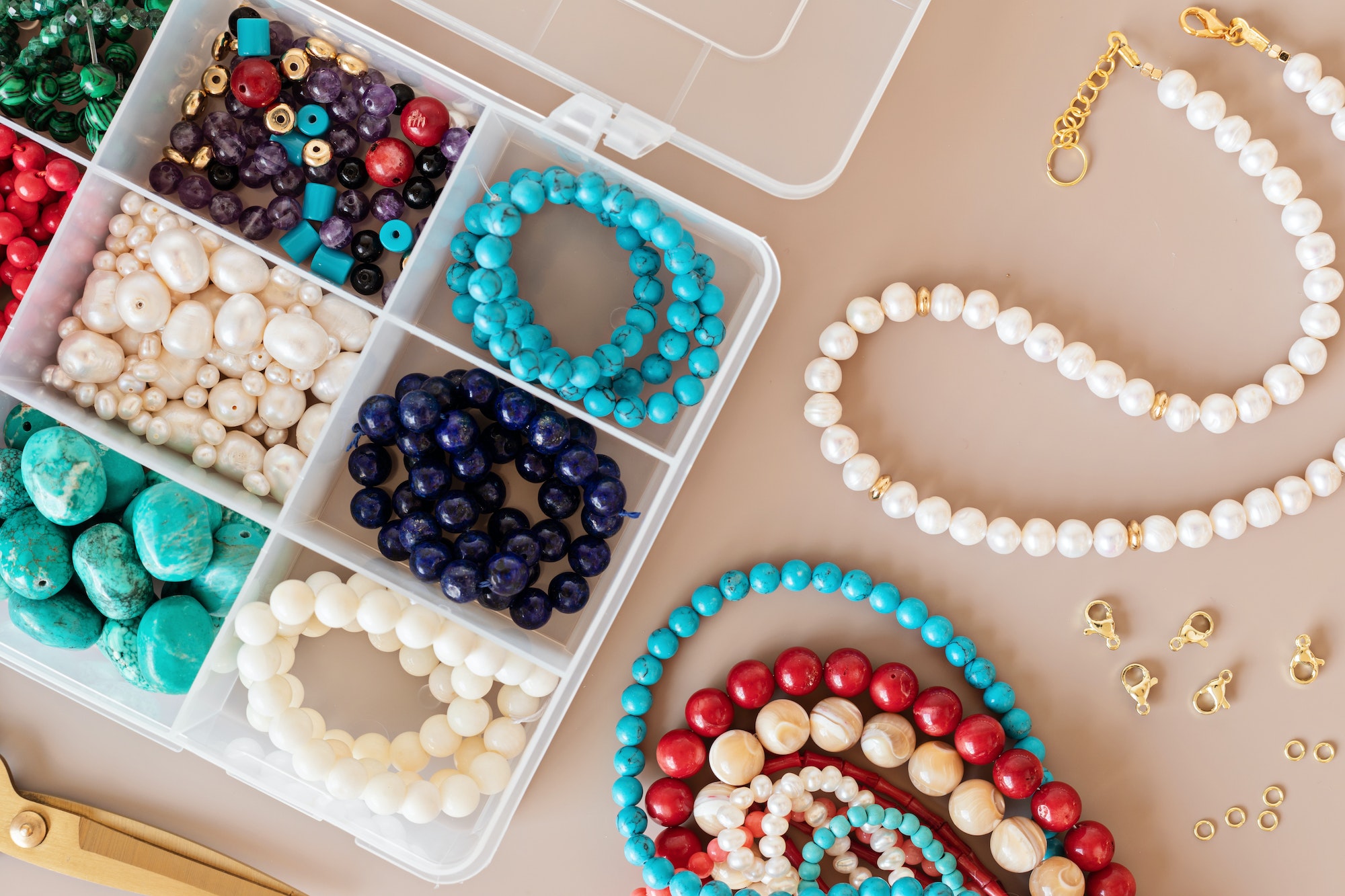Jewelry making flatlay with semi-precious stone beads and tools