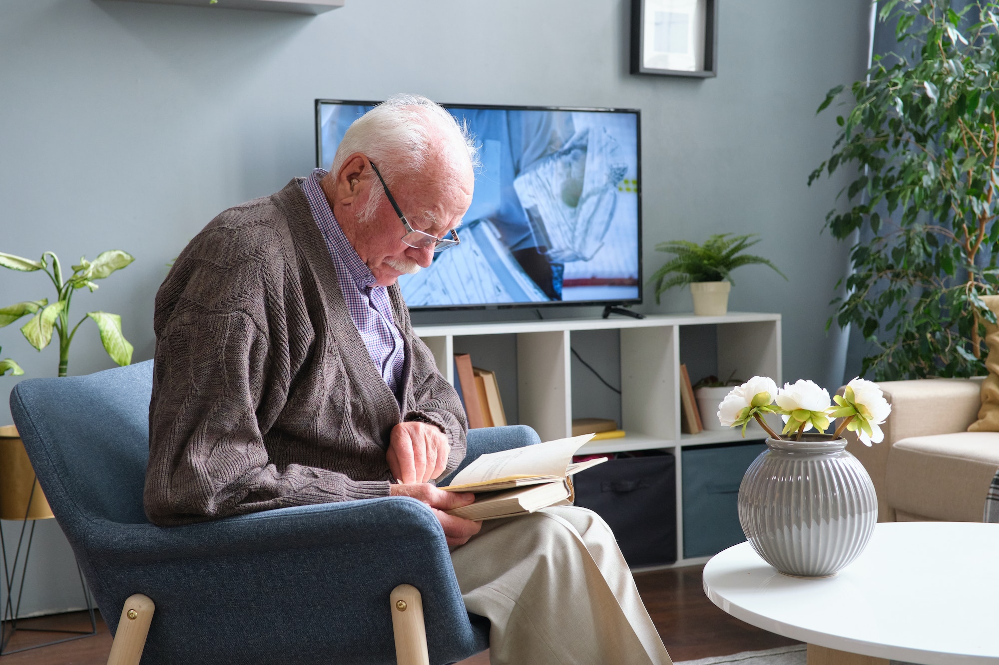 Senior man reading a book at home